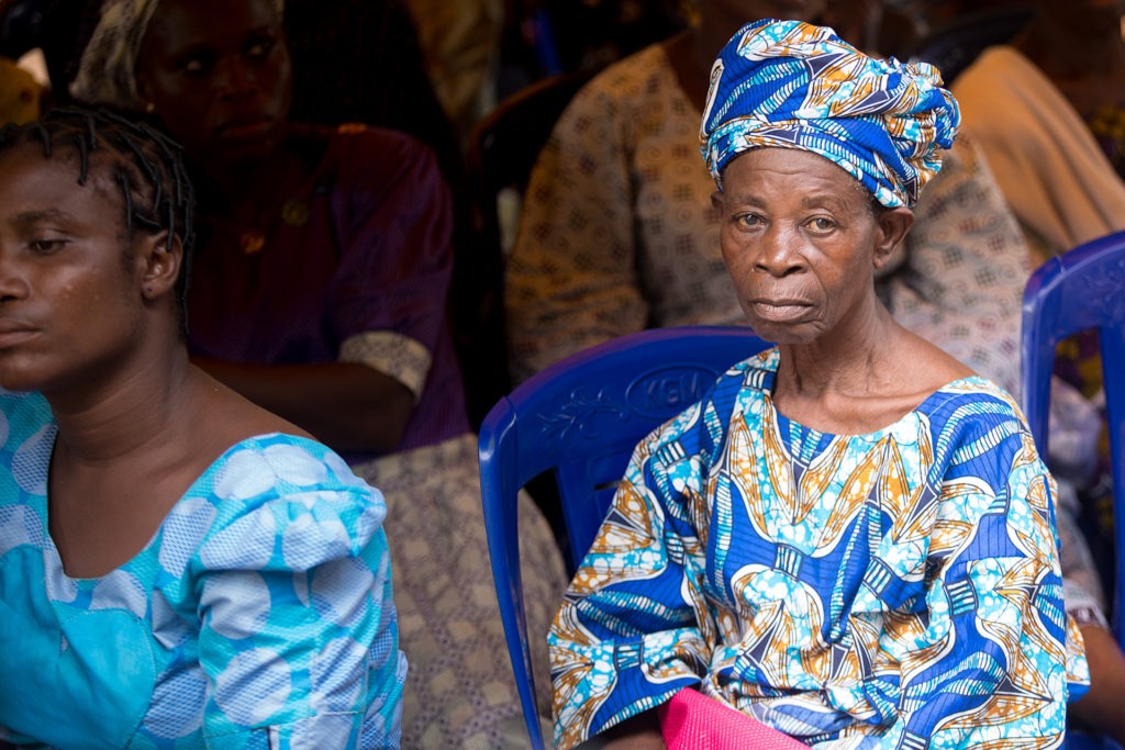 Picture of an old lady wearing Iro and Buba in blue and yellow ankara print.